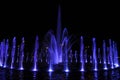 Fountain water stream jets in a ring at dark night Royalty Free Stock Photo