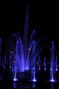 Fountain water stream jets in a ring at dark night Royalty Free Stock Photo