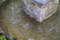 Fountain water stream splashing in the middle of the old marketplace. An old classic style stone Royalty Free Stock Photo