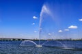 Fountain White Swan in Dnieper river against the background of the Central Bridge in Dnipro Ukraine on a sunny summer day. White