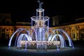 Fountain in winter for the new year decorated with light bulbs