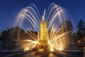 Fountain `Zolotoy Kolos` `Golden spike` on the territory of the All-Russian exhibition center VDNH in the evening. Moscow