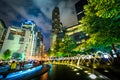 Fountains and buildings at night at Columbus Circle, in Manhatta