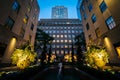 Fountains and buildings at Rockefeller Center at night, in Midto