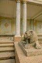 Fountains of Peterhof. Statue of stone lion near columns in Peterhof park