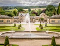 Fountains in a botanical garden, fields and clouds in the background Royalty Free Stock Photo
