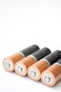 Four AA alkaline batteries on a white background