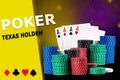 Four aces behind stacks of chips, black sparkling background. Inscription poker and texas holdem, card suits on yellow Royalty Free Stock Photo