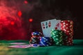 Four aces and colorful stacks of chips on green casino table and red background.Macro.AI Generative Royalty Free Stock Photo