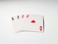 Four aces from a deck of playing cards isolated on a white background. Pik, club, diamond and heart suit Royalty Free Stock Photo