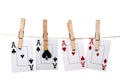Four aces hanging from clothes pegs on a clothes l Royalty Free Stock Photo