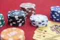 Four of aces near stacks of chips on a red felt table