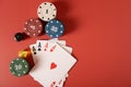 Four aces on playing cards and casino chips on a red background Royalty Free Stock Photo