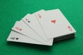 Four aces playing cards on green table, closeup. Poker game Royalty Free Stock Photo