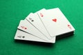 Four aces playing cards on green table, closeup. Poker game Royalty Free Stock Photo