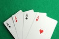 Four aces playing cards on green table, top view. Poker game Royalty Free Stock Photo