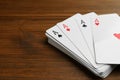 Four aces playing cards on wooden table, closeup. Space for text Royalty Free Stock Photo