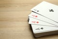 Four aces playing cards on wooden table. Space for text Royalty Free Stock Photo