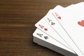 Four aces playing cards on wooden table, closeup. Space for text Royalty Free Stock Photo