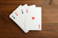 Four aces playing cards on wooden table, flat lay Royalty Free Stock Photo