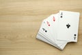 Four aces playing cards on wooden table, flat lay. Space for text Royalty Free Stock Photo