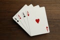 Four aces playing cards on wooden table, top view. Poker game Royalty Free Stock Photo