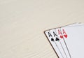 four aces poker hands playing cards on a light desk background. Royalty Free Stock Photo