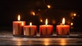 Four Advent candles in Christmas time, Advent season. Flickering flames cast soft in the dark with bokeh, inviting glow,