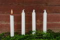 Four advent candles at an old plank wall Royalty Free Stock Photo