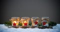 Four Advent candles in the snow