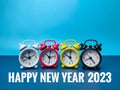 Alarm clocks with the word Happy New Year 2023 on blue background