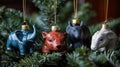 Four Animal-Shaped Christmas Ornaments Hanging on a Pine Tree Branch Royalty Free Stock Photo
