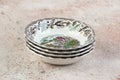 Four antique porcelain bowls on concrete Royalty Free Stock Photo