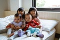 Four Asian children smile when sitting on the bed Royalty Free Stock Photo