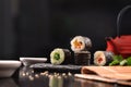 Four assorted vegetable sushi on slate plate on table dark Royalty Free Stock Photo