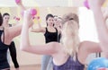 Four Athletic Caucasian Women Doing Work Out Exercises with Barbells in Gym