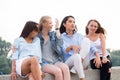 Portrait Of Four Attractive Young Women In Studio Standing In Line