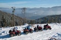 Four ATV riders on off-road quad bikes on snow in winter Royalty Free Stock Photo