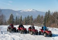 Four ATV riders on off-road quad bikes in winter Royalty Free Stock Photo