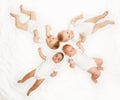 Four babies lay in star shape on white background Royalty Free Stock Photo