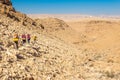 Four backpackers hiking trail, Negev desert, Israel.
