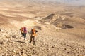 Four backpackers hiking trail, Negev desert, Israel.