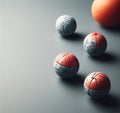 Four balls that are on a table with an orange in the background Royalty Free Stock Photo