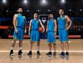 Four basketball players standing on basketball court
