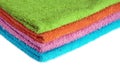 Four bath towels of different colors stacked isolated