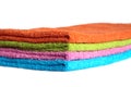 Four bath towels of different colors stacked isolated