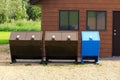 Four bear proof garbage cans with a recycle bin Royalty Free Stock Photo