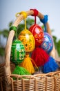 Four beautiful hand painted Easter eggs, made of wood in a brown wicker basket Ã¢â¬â decoration of a holiday table during celebratio Royalty Free Stock Photo