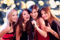 Four beautiful girls singing karaoke Royalty Free Stock Photo