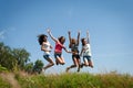 Four beautiful happy teen girls friends jumping Royalty Free Stock Photo